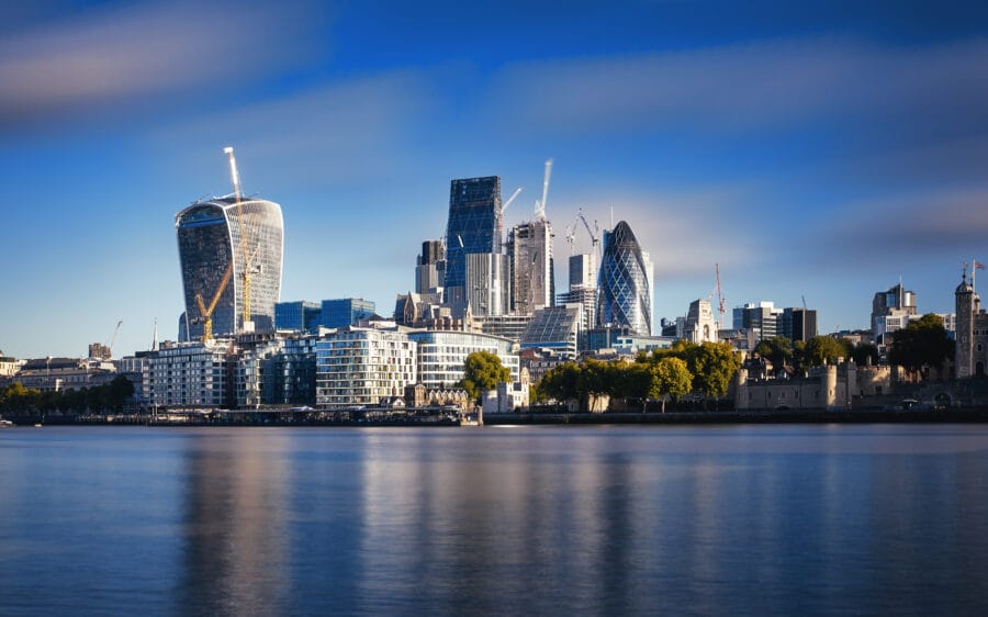 Photograph of London City Skyline at River Thames. Blue sky and sunny day
